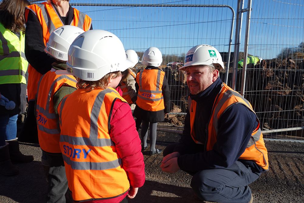 School children get a lesson in house building