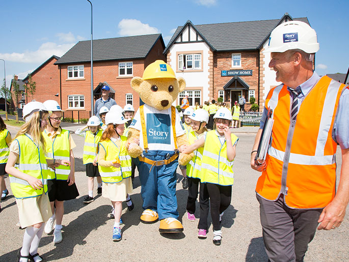 Builder Bear joins schoolchildren from St Michael’s Primary School to learn about building houses