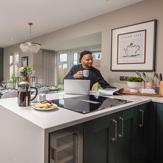 Customer-at-kitchen-island-in-The-Hewson-Story-home